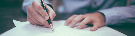 Person writing on documents